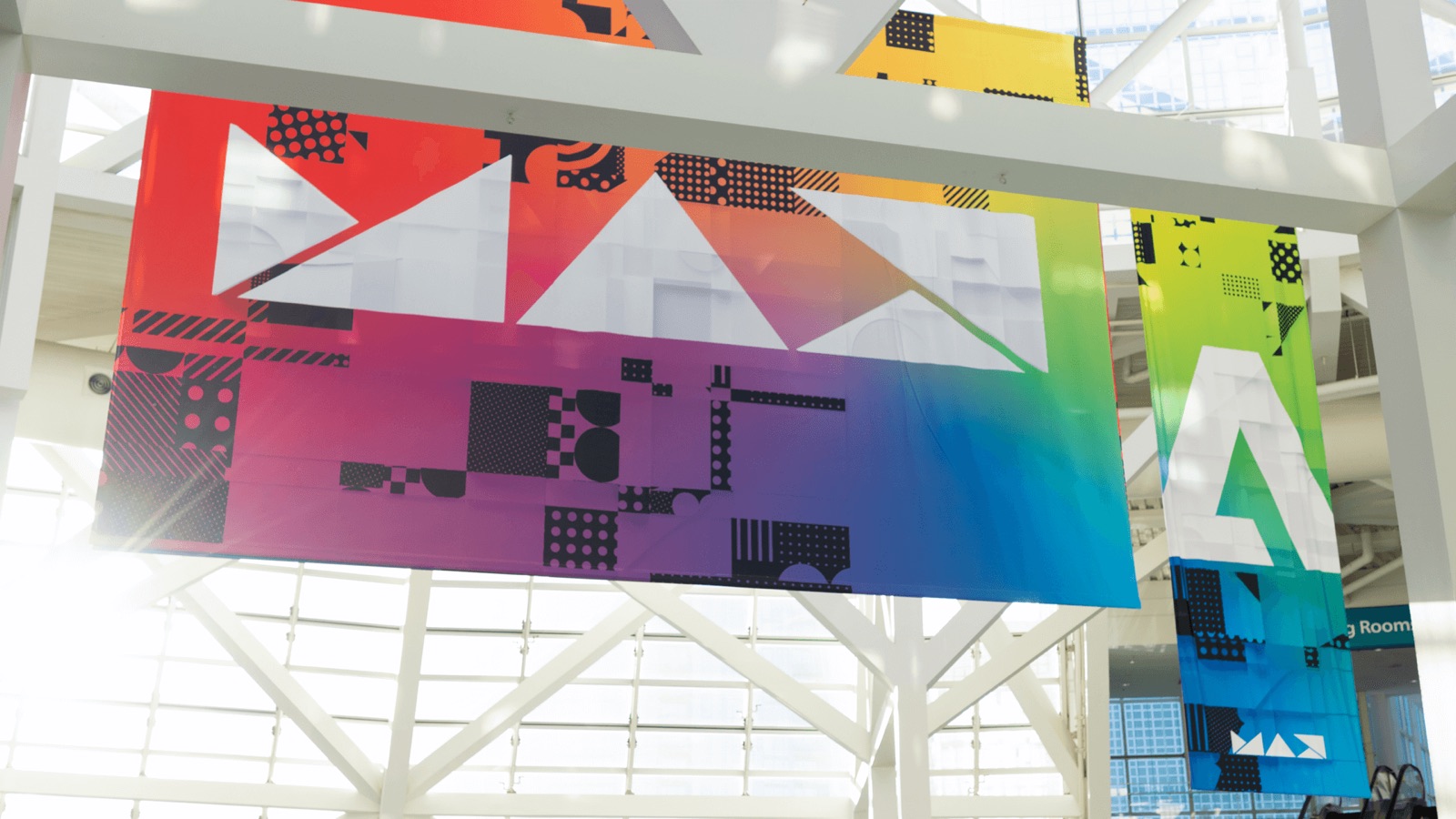 Colorful Adobe MAX banners hanging in a conference hall