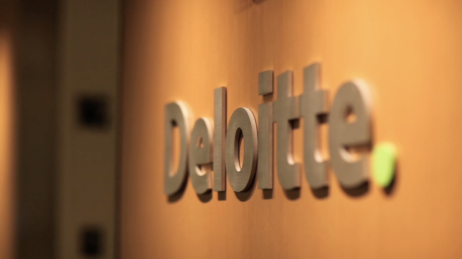 Deloitte logo on an office wall